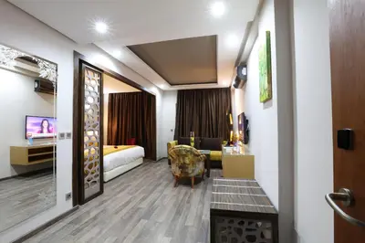 a hotel room with a bed and a couch at Silver Suites Hotel & Spa Casablanca in Casablanca