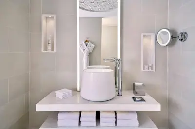 a bathroom with a sink and a mirror and towels at Rabat Marriott Hotel in Rabat