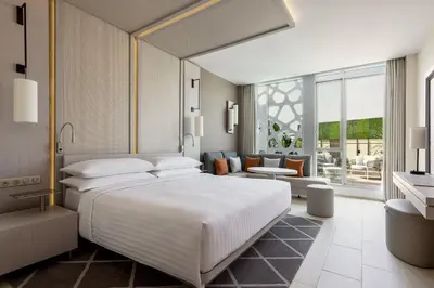 a bedroom with a large bed and a living room at Rabat Marriott Hotel in Rabat