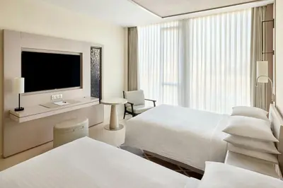a hotel room with two beds and a flat screen tv at Rabat Marriott Hotel in Rabat