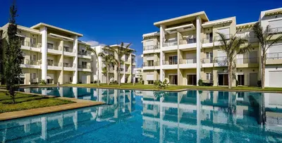 a swimming pool in front of a building at CASA BAY BEACH OMK in Sidi Rahal