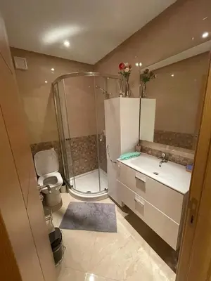 a bathroom with a shower and a sink and a toilet at CASA BAY BEACH OMK in Sidi Rahal