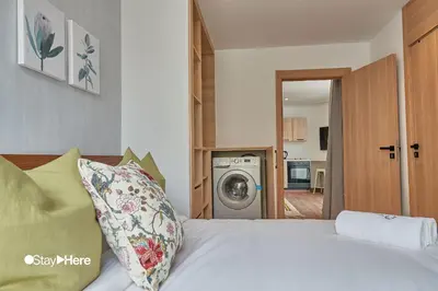 a bedroom with a bed and a washing machine at Stayhere Casablanca - Palmier - Executive Residence in Casablanca