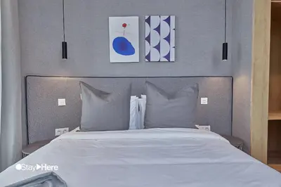 a bed with white sheets and pillows in a bedroom at Stayhere Casablanca - Palmier - Executive Residence in Casablanca