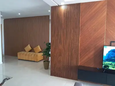 a living room with a large wooden wall at bouzkina Costa beach golf in Bouznika
