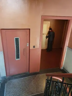 a man standing in a hallway taking a picture at HOTEL DU LOUVRE in Casablanca