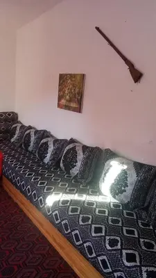 a couch with pillows on it in a room at Khaima in Souk Jemaa des Oulad Abbou