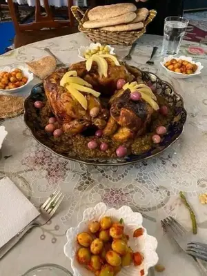 a table with a turkey and other food on it at Khaima in Souk Jemaa des Oulad Abbou