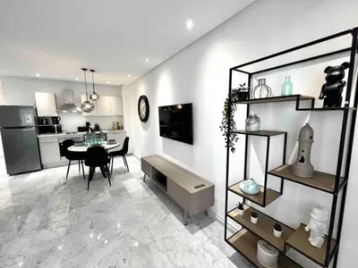 a kitchen and dining room with a table and a dining room at Gauthier Living by ShortStayMaroc, Appartement Équipé, Centre, 1 ou 2 Chambres in Casablanca