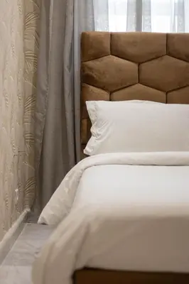 a bedroom with a white bed and a window at Gauthier Living by ShortStayMaroc, Appartement Équipé, Centre, 1 ou 2 Chambres in Casablanca