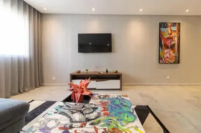 a living room with a flat screen tv on a wall at Gauthier Living by ShortStayMaroc, Appartement Équipé, Centre, 1 ou 2 Chambres in Casablanca
