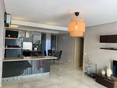 a living room with a kitchen and a dining room at #10 Racine triangle d or near aindiab in Casablanca