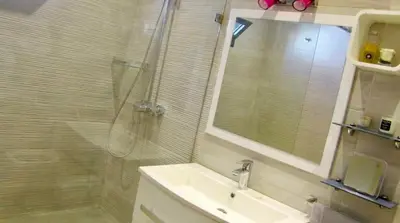 a bathroom with a sink and a glass shower at #10 Racine triangle d or near aindiab in Casablanca