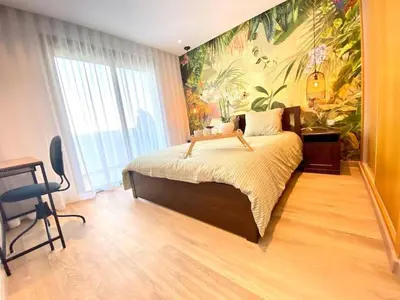 a bedroom with a large bed with a painting on the wall at Anfa Living 23-BREATHTAKING SEA VIEW NEW&CHIC 5 in Casablanca