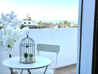 a bird cage sitting on a table on a balcony at Anfa Living 23-BREATHTAKING SEA VIEW NEW&CHIC 5 in Casablanca