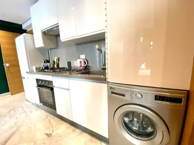 a kitchen with a washing machine in a kitchen at Anfa Living 29-The Gatsby 5 Chic&New Apt near Sea in Casablanca