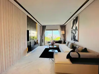 a living room with a couch and a table at ANFA LIVING - Front Sea VIEW 180 -2 or 3 bedrooms- LES TERRASSES D'ANFA by ShortStayMaroc in Casablanca