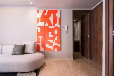 a living room with a couch and a painting on the wall at Luxoria by ShortStayMaroc, Studio Moderne et Chic, Parking, Quartier Central in Casablanca