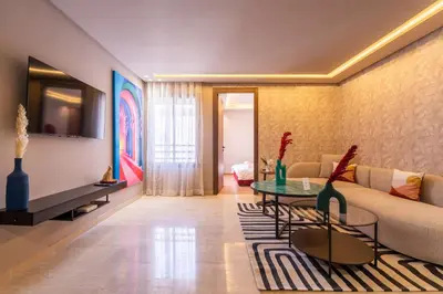 a living room with a couch and a table at Luxoria by ShortStayMaroc, Studio Moderne et Chic, Parking, Quartier Central in Casablanca