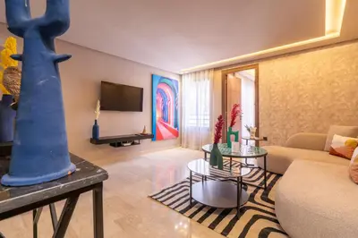 a living room with a couch and a table at Luxoria by ShortStayMaroc, Studio Moderne et Chic, Parking, Quartier Central in Casablanca