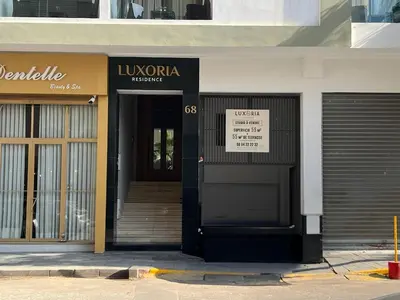 a front door of a building with a sign on it at Luxoria by ShortStayMaroc, Studio Moderne et Chic, Parking, Quartier Central in Casablanca
