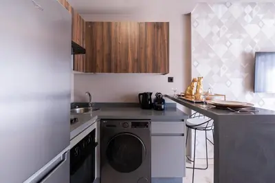 a kitchen with a washer and a dishwasher at Luxoria by ShortStayMaroc, Studio Moderne et Chic, Parking, Quartier Central in Casablanca