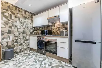 a kitchen with a stove and a washer and dryer at Metropolitan 19- 2 BEDROOMS with terrace NEW&SUNNY in Casablanca