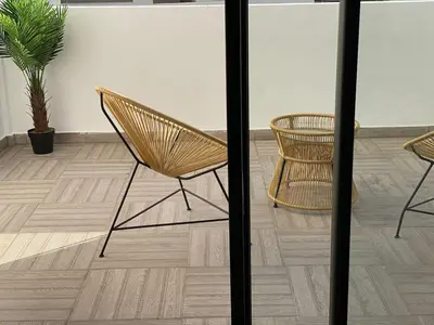 two chairs and a table in a room at Metropolitan 19- 2 BEDROOMS with terrace NEW&SUNNY in Casablanca