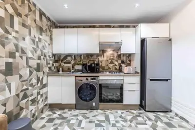 a kitchen with a refrigerator and a dishwasher at Metropolitan 19- 2 BEDROOMS with terrace NEW&SUNNY in Casablanca