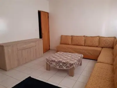 a living room with a couch and a coffee table at Les Appartements de Massira in Temara