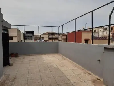 an empty room with a fence on top of a building at Les Appartements de Massira in Temara