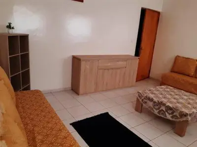 a living room with a couch and a chair at Les Appartements de Massira in Temara
