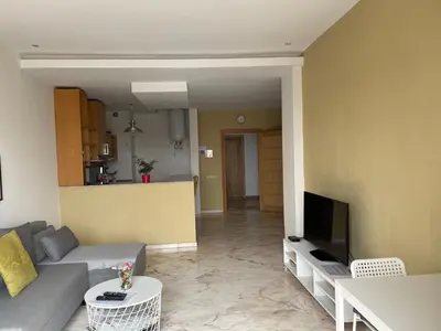 a living room with a couch and a tv at Airport to Comme à la maison 2 in Derroua