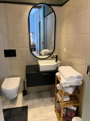 a bathroom with a sink and a mirror and a toilet at Luxurious Appart near tramway #fibre optique in Casablanca
