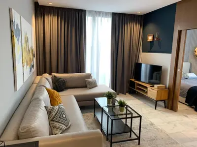 a living room with a couch and a television at Luxurious Appart near tramway #fibre optique in Casablanca