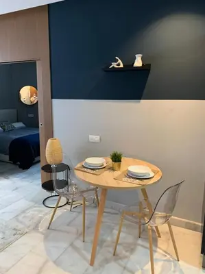 a dining table and chairs in a living room at Luxurious Appart near tramway #fibre optique in Casablanca