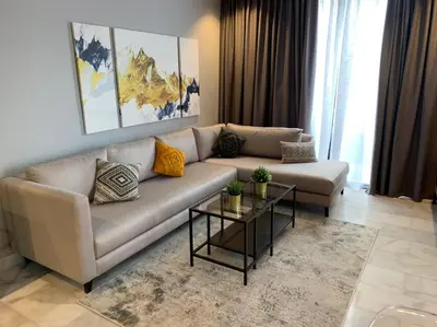 a living room with a couch and a table at Luxurious Appart near tramway #fibre optique in Casablanca