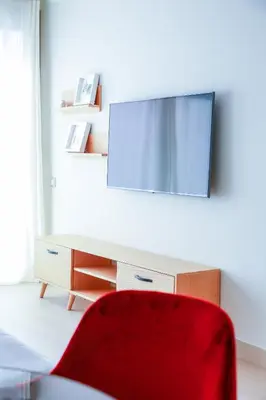 a red chair in front of a desk with a mirror at #13 Fresh Appart in new residence in Casablanca