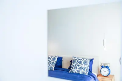 a bed with blue sheets and pillows in a bedroom at #13 Fresh Appart in new residence in Casablanca