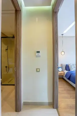 a pivot door in a room with a bedroom at #34 New Flat in new Garden Residence in Casablanca