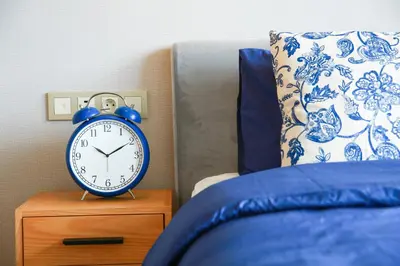 a blue alarm clock sitting on top of a bed at #34 New Flat in new Garden Residence in Casablanca