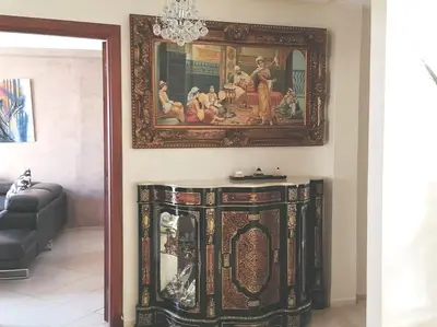 a living room with a painting on the wall at Grand Appartement à 5 min de la mer et de la mosqué hassan II de Casablanca in Casablanca