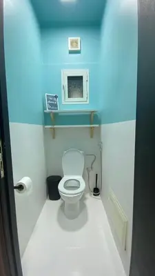 a small bathroom with a toilet in a blue room at RABAT Residence - OCEAN STAY in Rabat