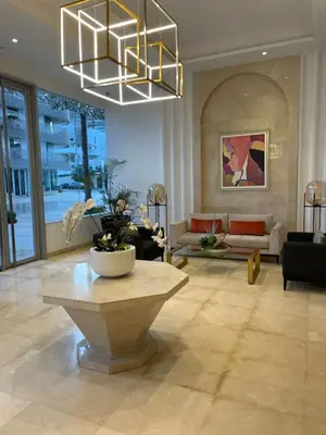 a living room with a large lobby with a table at Appartement Anfa Park casa finance City CFC in Casablanca