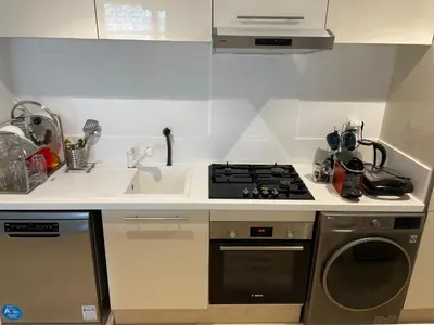 a kitchen with a stove top oven next to a sink at Appartement Anfa Park casa finance City CFC in Casablanca