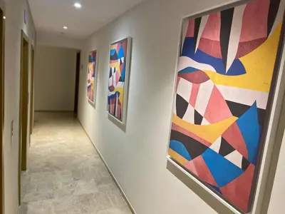 a hallway with colorful paintings on the wall at Appartement Anfa Park casa finance City CFC in Casablanca