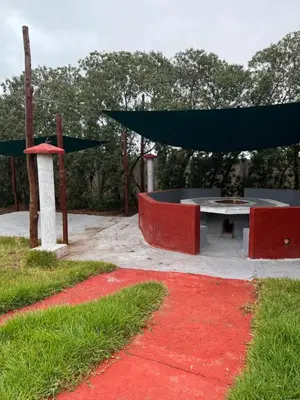 a picnic table in a park with a red carpet at Atlantic Vacation villa in Dar Oulad Hajj Kassem