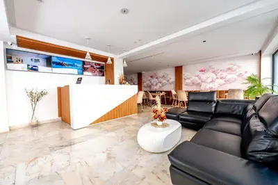 a living room with black leather furniture and a bar at Family Aparthotel in Casablanca