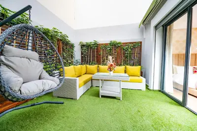a room with a yellow couch and a swing at Family Aparthotel in Casablanca