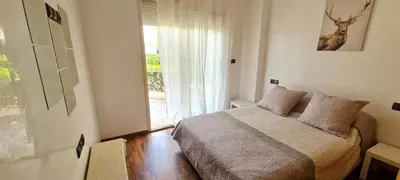 a bedroom with a bed and a large window at Bel appartement Savannah Beach in Sidi Rahal